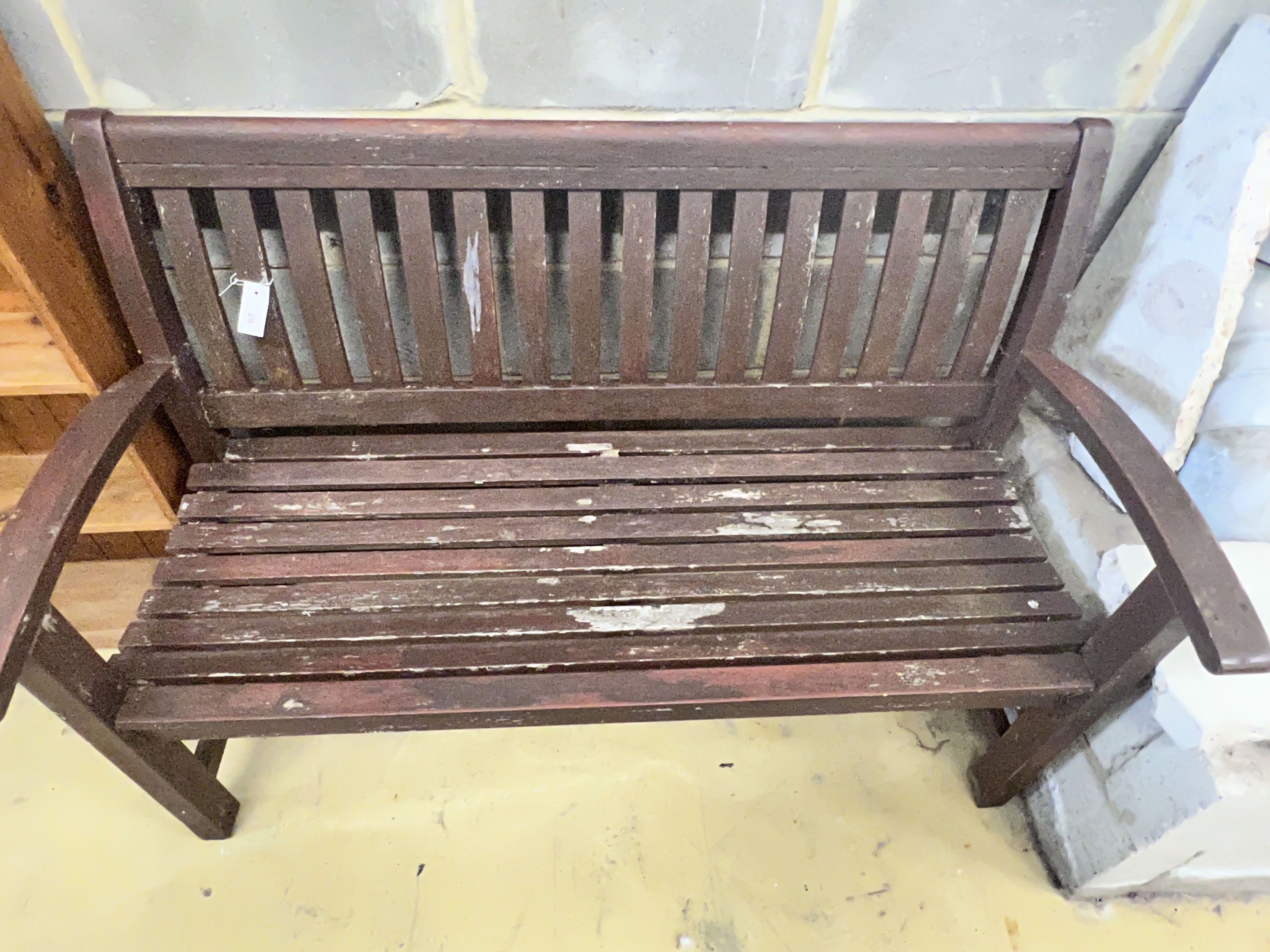 A stained teak slatted garden bench, 138 x 58cm height 92cm